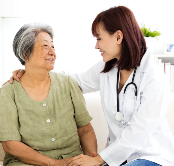 Smiling home caregiver with senior woman